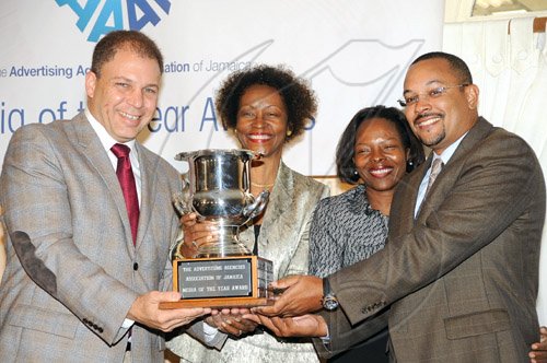 Rudolph Brown/Chief Photographer
Arnold J Foote, (left) president of the Advertising Agencies Association of Jamaica, presents the winning award for media of the year to The Gleaner's Nordia Craig (second right) Yvonne Senior, (second left) and Christopher Barnes, (right) deputy managing director of The Gleaner Company at AAAJ Media Awards 2009 at AAAJ Media awards luncheon at Knutsford Court Hotel  New Kingston. on Wednesday, June 10-2009