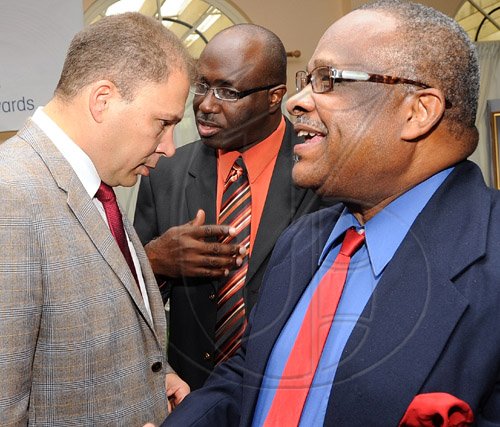 Rudolph Brown/Chief Photographer
Arnold J Foote, (left) president of the Advertising Agencies Association of Jamaica, in discussion with media Personality of the year to Lloyd B Smith, (right) and Gary Allen, Chairman Media Association of Jamaica at AAAJ Media awards luncheon at Knutsford Court Hotel  New Kingston. on Wednesday, June 10-2009