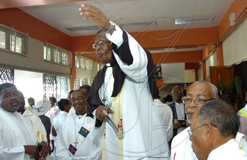 Rudolph Brown/Chief Photographer
Rev. Major Sirrano Kitson speaks to members of the Clergy before The Rt. Rev. Alfred Reid, Bishop of Jamaica and the Cayman Islands and Archbishop of Canterbury The Most Rev. and Rt. Hon. Dr. Rowan Williams enter the National Arena for the Diocese of Jamaica and the Cayman Islands, Order of Service on the occasion of the meeting of the Anglican Consultative Council on Sunday, May 3-2009.