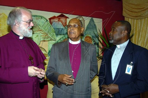 Peta-Gaye Clachar/Staff Photographer
Archbishop of Canterbury, Most Rev and Right Honourable Rowan Williams (left) engages in conversations with Right Reverend the Honourable Alfred Reid (center) Bishop of Jamaica and Cayman Islands (second right) and Reverend Denzil Barnes Diocesan Secretary during the official welcome on the arrival in Jamaica of the Archbishop of Canterbury, Most Reverend and Right Honourable Rowan Williams at the Norman Manley International Airport on Wednesday, April 29, 2009.