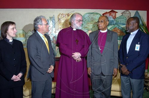 Peta-Gaye Clachar/Staff Photographer
Archbishop of Canterbury, Most Rev and Right Honourable Rowan Williams (center) engages in conversations with Right Reverend the Honourable Alfred Reid, Bishop of Jamaica and Cayman Islands (second right) and Reverend Denzil Barnes Diocesan Secretary as Reverend Canon Joanna Udal (left) Chaplain to the Archbishop and Jeremy Cresswell lBritish High Commissioner ooks on during the official welcome on the arrival in Jamaica of the Archbishop of Canterbury, Most Reverend and Right Honourable Rowan Williams at the Norman Manley International Airport on Wednesday, April 29, 2009.