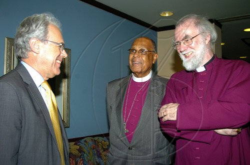 Peta-Gaye Clachar/Staff Photographer
British High Commissioner Jeremy Cresswell (left) have talks with the Archbishop of Canterbury, Most Rev and Right Honourable Rowan Williams (right) during his official welcome on his arrival in Jamaica at the Norman Manley International Airport on Wednesday, April 29, 2009. Looking on is the Right Reverend the Honourable Alfred Reid, Bishop of Jamaica and Cayman Islands.