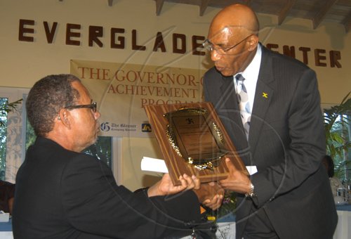 Contribution                                                                                                                                                                                                                                                                               Principal of the Black River High School, the Reverend Dr. Barrington Buchanan (left), accepting his award from Governor-General, His Excellency the Most Hon. Sir  Patrick Allen, at a presentation ceremony, held in Parottee, St. Elizabeth, on August 25.