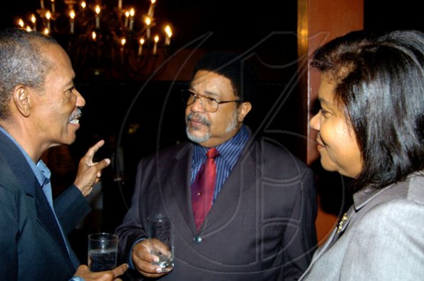 Winston Sill / Freelance Photographer
Conferment of the Order of the Civil Merit of Spain on Edmund Bartlett, Minister of Tourism, at a reception hosted by Ambassador Jesus Silva and Sara Silva, held at Norbrook Road on Friday night May 7, 2010. Here are  Kent Pantry (left); William McCalla (centre); and Chief Justice Zaila McCalla (right).