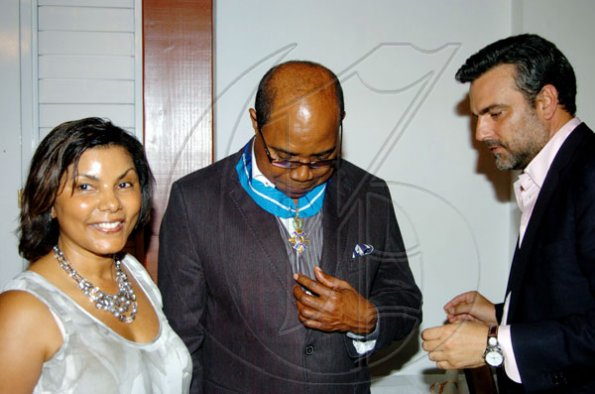 Winston Sill / Freelance Photographer
 Carmen Bartlett, is all smiles as hubby, Toursm Minister Edmund Bartlett (centre), examines his medal after Spanish  Ambassador Jesus Silva  placed it around his neck. It's the Order of the Civil Merit of Spain and the event was a reception hosted by Ambassador and Mrs Silva, at Norbrook Road on Friday night.




***************************************************************************************************** May 7, 2010. Here are  (Mrs.) Carmen Bartlett (left); Ed. Bartlett (centre); and Ambassador Silva (right).