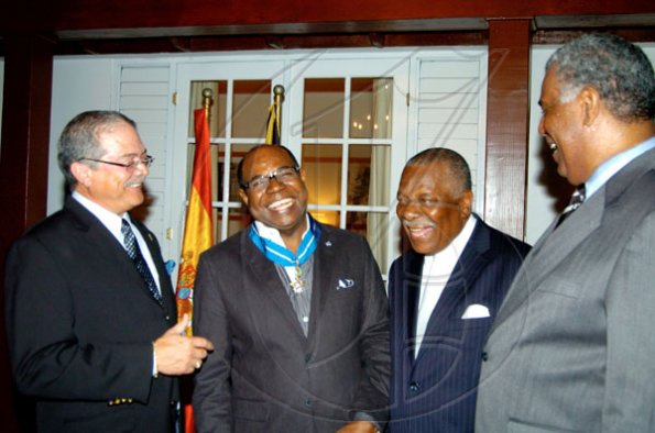 Winston Sill / Freelance Photographer
Conferment of the Order of the Civil Merit of Spain on Edmund Bartlett, Minister of Tourism, at a reception hosted by Ambassador Jesus Silva and Sara Silva, held at Norbrook Road on Friday night May 7, 2010. Here are  Robert Russell (left); Ed. Bartlett (second left); Godfrey Dyer (second right); and John Lynch (right).
