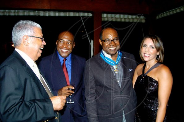 Winston Sill / Freelance Photographer
Conferment of the Order of the Civil Merit of Spain on Edmund Bartlett, Minister of Tourism, at a reception hosted by Ambassador Jesus Silva and Sara Silva, held at Norbrook Road on Friday night May 7, 2010. Here are Winston Dear (left); Clive Mullings (second left); Ed.Bartlett (second right); and Paula Kerr-Jarrett (right).