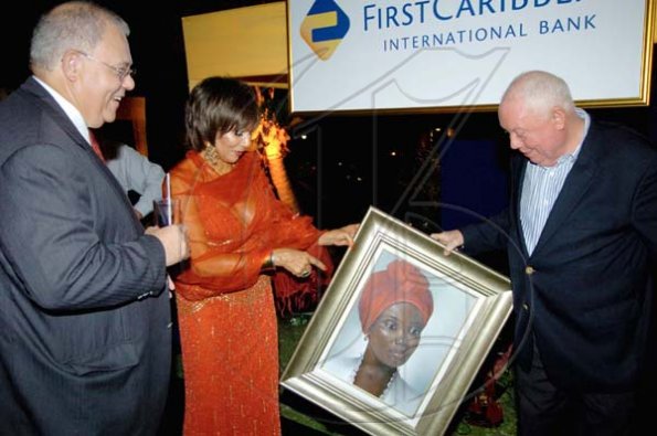 Winston Sill / Freelance Photographer
Former director of FirstCaribbean International Bank Chris Bovell (right) along with wife Michelle, seems more than pleased with the painting he received as his farewell gift. FirstCaribbean Chairman Michael Mansoor seems to think it's a keeper as well.
Farewell Function for Christopher Bovell, held at the Jamaica Pegasus Hotel, New Kingston night December 17, 2009.