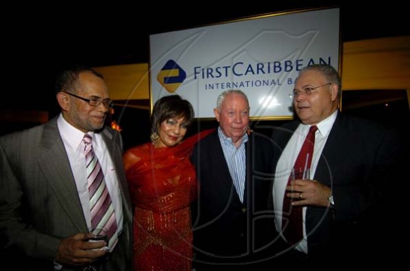 Winston Sill / Freelance Photographer
FirstCaribbean (Jamaica operations) Managing Director Clovis Metcalfe (left) and FirstCaribbean Chairman Michael Mansoor (right) sandwich the happy couple, Chris and Michelle Bovell.
Bank Farewell Function for Christopher Bovell, held at the Jamaica Pegasus Hotel, New Kingston night December 17, 2009.