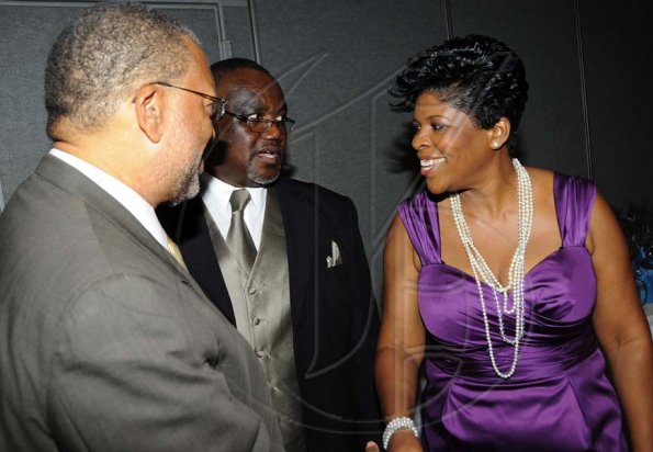 Rudolph Brown/Photographer
Marcia Richards, (right) of Sagicor Life and Marston Thomas, Branch Manager greets guest speaker Dr. Peter Phillips at the Sagicor Life Jamaica Half Way Tree branch annual awards breakfast at the Jamaica Pegasus Hotel in New Kingston on Friday, March 26-2010.