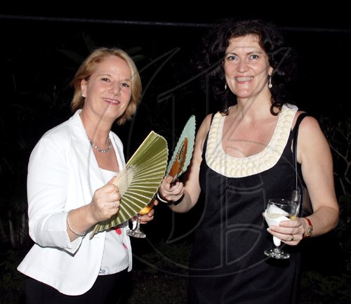 Colin Hamilton/freelance photographer
FAN CLUB: Dr. Barbara Munske-Cresswell left) and the British High Commission's  project officer, Jo Seaman deal with the tropical weather during the reception for the British DPP Keir Starmer, QC..

****************************************************************** at the British High Commission on Monday September 28, 2009.