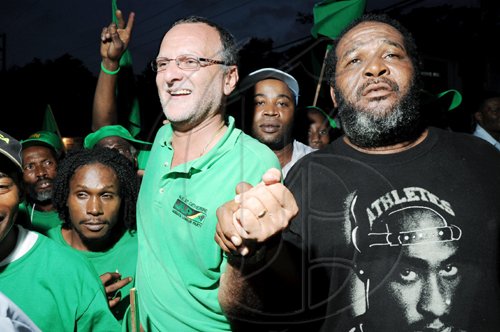 Ricardo Makyn/Staff Photographer
Jamaica Labour Party candidate Gregory Mair (centre) celebrates with jubilant supporters after winning Tuesday's by-election in the North East St Catherine constituency.