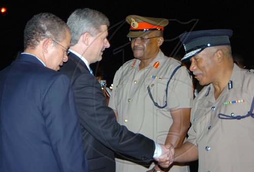 Rudolph Brown/Chief Photographer
Prime Minister Bruce Golding (left) welcomes Canadian Prime Minister Stephen Harper, (second left) to Jamaica shortly after both leaders landed at the Norman Manley International Airport yesterday. Harper and Golding  were returning from the Fifth Summit of the Americas which was held in Trinidad and Tobago. Harper is on an official visit to Jamaica.Prime Minister Harper greets Chief of Defence Staff Major General Stewart Saunders, (second right) and Police Commissioner Rear Admiral Hardley Lewin, (right)