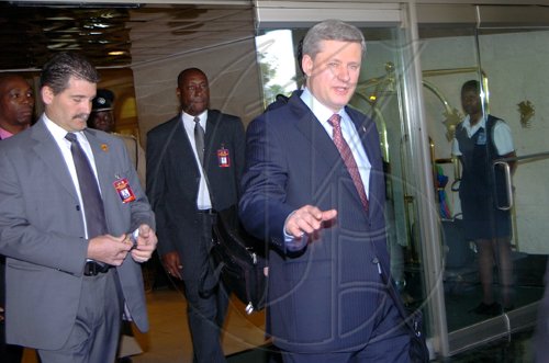 Rudolph Brown/Chief Photographer
Canadian Prime Minister Stephen Harper, (right) leaves the Jamaica Pegasus Hotel to board a flight to Montego Bay for press conference after a gunman boarded a plane on the at the Sangster International Airport and held the crew and 140 passengers hostage on Monday , April 20-2009. Harper is on an official visit to Jamaica.