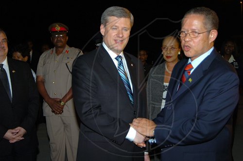Rudolph Brown/Chief Photographer
The Right Honourable Stephen Harper Prime Minister of Canada vist to  Jamaica.
 Rudolph Brown/Chief Photographer
Prime Minister Bruce Golding (right) welcomes Canadian Prime Minister Stephen Harper to Jamaica shortly after both leaders landed at the Norman Manley International Airport yesterday. Harper and Golding  were returning from the Fifth Summit of the Americas which was held in Trinidad and Tobago. Harper is on an official visit to Jamaica. In the backround are (from left) Canadian High Commissioner Denis Kingsley; Chief of Defence Staff Major General Stewart Saunders; Police Commissioner Rear Admiral Hardley Lewin and Chief Medical Officer Dr Marion Bullock-Ducasse.