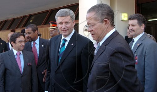 Rudolph Brown/Chief Photographer
Canadian Prime Minister Stephen Harper speaks to Prime Minister Bruce Golding after speaking to the House of parliament, on Monday, April 20-2009 Prime Minister Harper on an official visit to Jamaica.