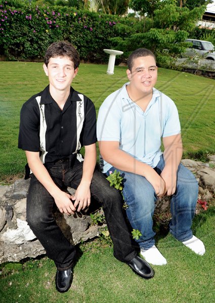 Ricardo Makyn/Staff Photographer.
Rory Thwaites (left) and Jason Baugh, nephews of Dr Gomes, preferred a quiet spot in the garden over the company of the adults upstairs.

(*****************************************************************************

to the company Function for Carolyn Gomes after receiving National Honour on Monday 19.10.2009.