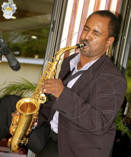 Colin Hamilton/Freelance Photographer
Saxophonist Warren Harris puts his all into entertaining guests at the 'Moments with Mom' Mother's Day brunch held at the Mona Visitors' Lodge, University of the West Indies, yesterday afternoon. Moms were lavished with meals fit for queens, lots of musical entertainment and a fashion show during the Gleaner-sponsored event.