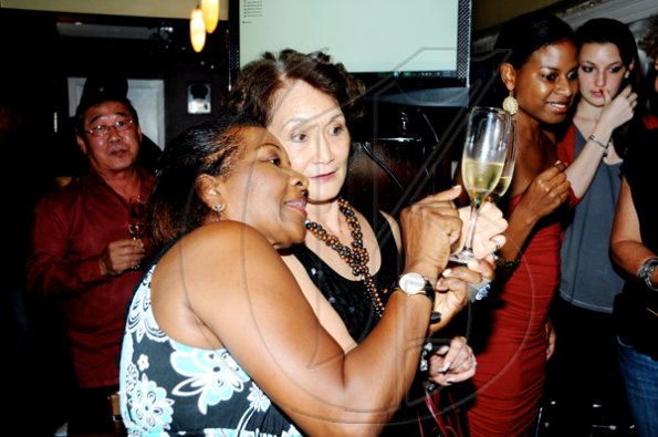 Winston Sill / Freelance Photographer
Marilyn Bennett (left) and Thalia Lyn getting a closer look at the rich colour the world best wine. 

************************************************************
Launch of Armand De Brignac Champagne, held at Bin 26, Devon House, Hope Road on Tuesday night July 5, 2011.