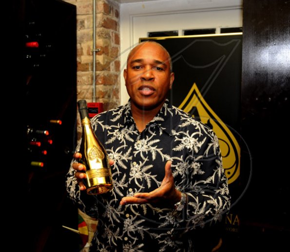 Winston Sill / Freelance Photographer
Christopher Reckord showing off a bottle of the Armand De Brignac. 
*******************************************************
Launch of Armand De Brignac Champagne, held at Bin 26, Devon House, Hope Road on Tuesday night July 5, 2011.