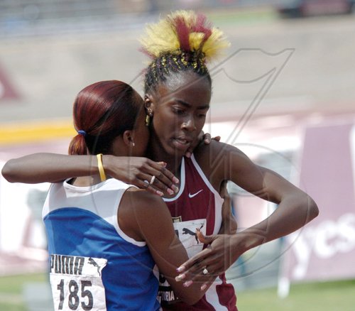 Ricardo Makyn/Staff Photographer
Edwin Allen's Sherene Pinnock (left) hugs Holmwood's Sonita Sutherland but check out the latter's up do!
*********************************************************************************************************************************hug each other after the 400m final. Sutherland won the event in a record 51.13 while Pinnock was second in 52.81.