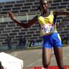 Ian Allen/Staff Photographer
St Elizabeth Technical High School's Rochelle Farquharson propels through the air as she competes in the Triple Jump Open final event, on the first day of the four-day ISSA/GraceKennedy Boys' and Girls' Athletic Championships at the National STadium. Farquhardon won with a best leap of 12.70 metres, a personal best.