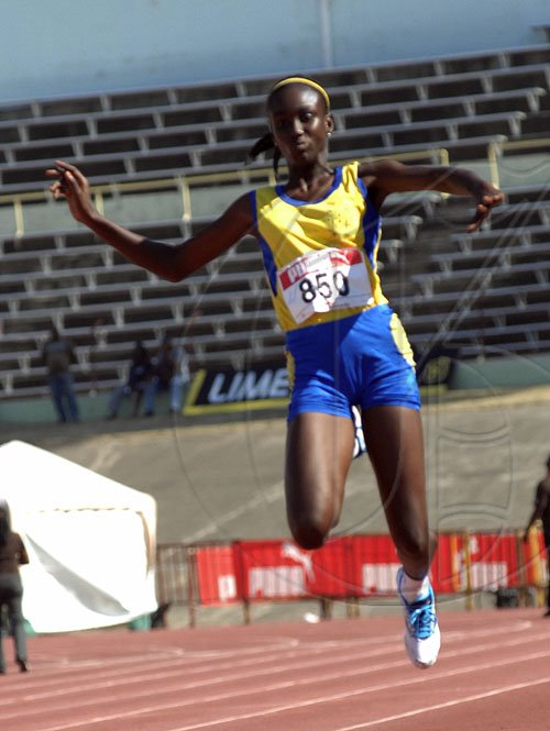 Ian Allen/Staff Photographer
St Elizabeth Technical High School's Rochelle Farquharson propels through the air as she competes in the Triple Jump Open final event, on the first day of the four-day ISSA/GraceKennedy Boys' and Girls' Athletic Championships at the National STadium. Farquhardon won with a best leap of 12.70 metres, a personal best.