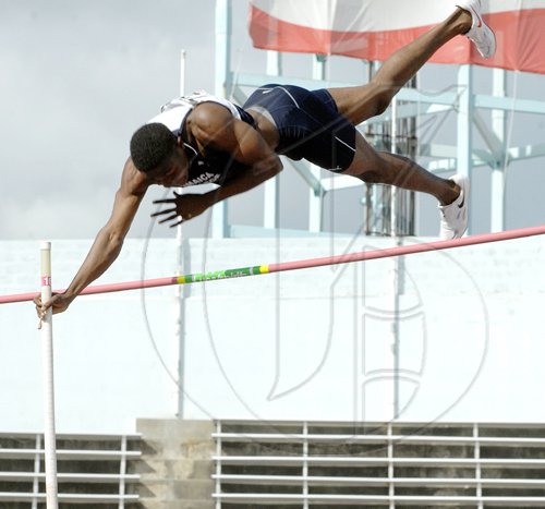 Ian Allen/Staff Photographer
K'Don Samuels of Jamaica College (JC) clears the bar at 4.45 metres to set a new record in the boys' pole vault, at the Inter-Secondary Schools Sports Association (ISSA)/GraceKennedy Boys and Girls' Athletic Championships, at the National Stadium yesterday.