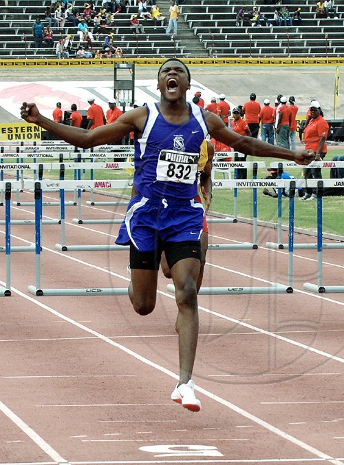 Ian Allen/Staff Photographer
Kingston College's co-captain Keiron Stewart celebrating victory in the Class One Boys 110m hurdles final at the National Stadium yesterday. Stewart clocked  13.79 seconds.