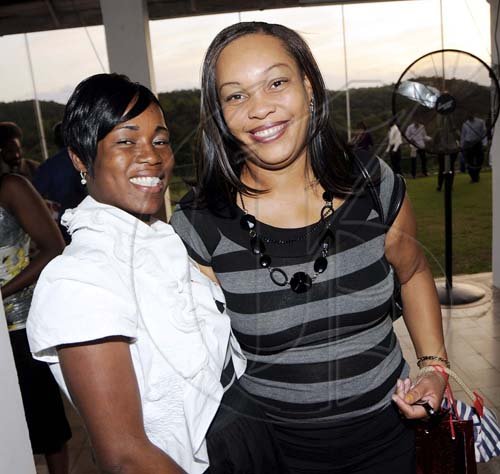 Rudolph Brown/Photographer
Dehandro Braithwaite (left) and Vinnett Myers are in the party mood.

**********************************************************************, at the St. Catherine Co-operative Credit Union Christmas awards luncheon at Caymanas Golf and Country Club on Wednesday, December 22-2010