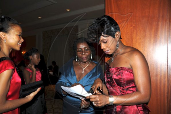 Publication: Social/Something Extra
Photo by Noel Thompson

Doris Morgan (centre), wife of Clayton Morgan and daughter Nneka Morgan-Sutton (right), look over the guests list during a celebration dinner held in honour of Clayton Morgan, at the Ritz Carlton Resort, Montego Bay, last Saturday (December 5, 2009). At left, a guest waits to be seated.
