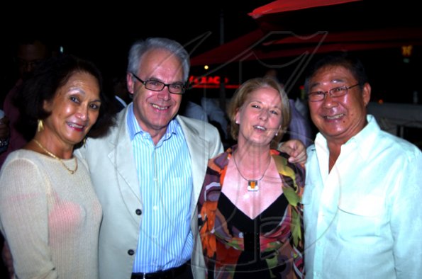 Winston Sill / Freelance Photographer
Honorary Consul to the Kingdom of Thailand Thalia Lyn (left) and husband Michael (right) cuddle up with the guests of honou, departing British High Commissioner Jeremy Cresswell and wife Dr. Barbara Munske.
, held at Spanish Court Hotel, New Kingston on Wednesday december 2, 2009.
