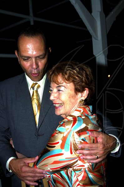 Winston Sill / Freelance Photographer
Glynne Manley gets a playful hug from William Tavares-Finson, dean of the Consular Corps of Jamaica.

presents High Tea and Unveiling of Plaque, held at King's House, Hope Road on Thursday January 21, 2010.