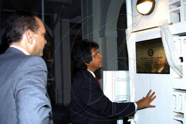 Winston Sill / Freelance Photographer
Honorary Consul of Ukraine Kenny Benjamin (right) checks the plaque commemorating the new tea garden, with Consular Corps of Jamaica dean William Tavares-Finson looking on.

presents High Tea and Unveiling of Plaque, held at King's House, Hope Road on Thursday January 21, 2010.