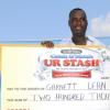 Garnett Dean posing with his cheque representing his winnings.