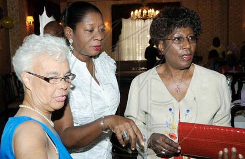 Rudolph Brown/Photographer
Lion Jean Munroe, (left) chat with Dr. Paulette McGregor, (centre) and Elve Passley at Lions Club of St. Andrew Central 18th anniversary celebration at Hotel Four Seasons on Sunday, March 7-2010