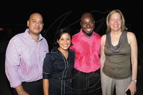 Rudolph Brown/Photographer
Anya Schnoor (right), executive vice president- Wealth Management and Insurance and chief executive officer Scotia DBG Investments, Monique Todd, (second left) director of wealth management marketing, pose for the camera with Garth Walker (second right) and Leighton Davis of Wealth Magazine.

**********************************************************  at the Wealth Magazine and Scotia DBG Investments Chicks and Balances Poolside party at Terra Nova Hotel in Kingston on Thursday, August 19-2010