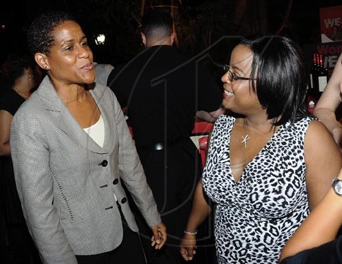 Rudolph Brown/Photographer
Janelle Brown (left) marketing and product manager, Retail Banking, Scotiabank, has a word with Vanessa  Reid Boothe.

***************************************************************************************** (left), of Scotiabank DBG Investments at the Wealth Magazine and Scotia DBG Investments Chicks and Balances Poolside party at Terra Nova Hotel in Kingston on Thursday, August 19-2010