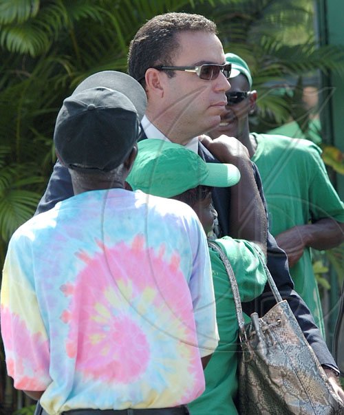 Rudolph Brown/Chief Photographer
Daryl Vaz, greets by members of the JLP after the Circuit Court ruling of the Dabdoub/Vaz case at the Jamaica Labour Party Headquarter on Friday, February 27-2009.