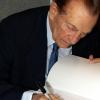 Contributed
Former Prime Minister Edward Seaga signs copies of his books at the launch.