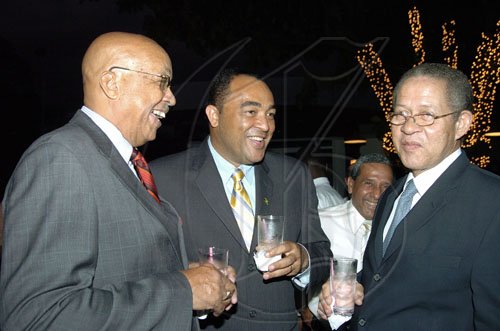 Peta-Gaye Clachar/Staff Photographer
Major Anthony Robinson (left) and Minister of Agriculture Christopher Tufton greats the Prime Minister Bruce Golding (right) at the after swearing in party for MP for West Portland Daryl Vaz at the Terra Nova Hotel on Tuesday, March 31, 2009.