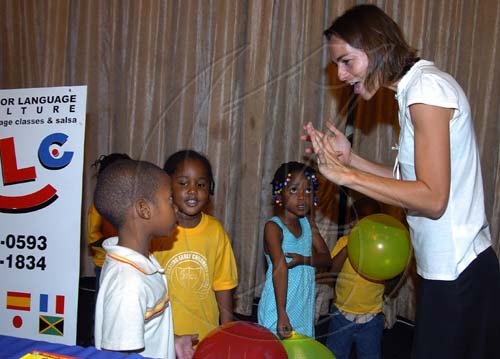 Peta-Gaye Clachar/Staff Photographer
Aline Luna Leclere-less (right) Director of the Center for Language and Culture (CLC) teaches some students  from the Little Darlings Early Childhood Center in Harbour View Kingston 17 to sing in french while at the Dudley Grant Memorial Trust Early Childhood 2009 Development Expo at the Jamaica Pegasus on Tuesday, July 7, 2009. Aline specializes in teaching basic school children in three languages, Spanish, French and English .From left to right is  Antwoine Chung, Julene Williams, Janielle Robinson and Rajhiem Blake (partially hidden).