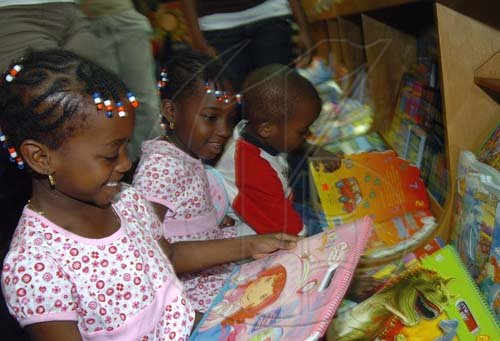 Peta-Gaye Clachar/Staff Photographer
Six years old Brianna Brown (left) is all smiles as she looks at the cover of a book as twin sister Tianna Dudley and brother Jordan searches through a host of books eagerly while at the Grant Memorial Trust Early Childhood 2009 Development Expo at the Jamaica Pegasus on Tuesday, July 7, 2009.