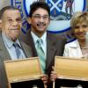 Ricardo Makyn/Staff Photographer
Phillip Duncan (left), former town clerk, displays the key to the city he received from the Kingston and St Andrew  Corporation (KSAC) on behalf of the late Marie Atkins, former mayor. Lorna Peralto (right), widow of the late Ryan Peralto, former parliamentarian and Kingston mayor, also received a key. Ryan Peralto Jr and Mishka Peralto watch from the background. The presentation took place during a parish council meeting at the KSAC Tuesday.
