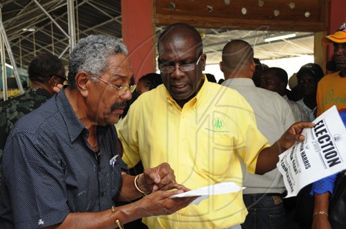 Ian Allen/Staff Photographer
Former JAS President Senator Norman Grant right check  the voters list with Noel Lee at the JAS elections at the Denbigh Showground in Clarendon on wednesday.