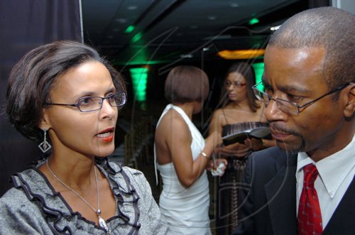 Rudolph Brown/Chief Photographer
Janet Sharp, executive vice-president resident actuary of Sagicor Life chat with Willard Brown vice president ,management and actuarial  at the Sagicor Life Jamaica annual corporate awards " With All Challenges Come Great Rewards" at the Hilton Hotel in New Kingston on Tuesday, March 17-2009.