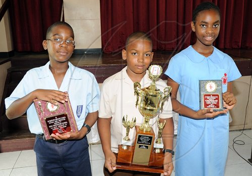 Rudolph Brown/Chief Photographer
First prize winner Timothy Hitchener, (centre) of Our Lady of the Angels Prep school, second prize, Jordan Salmon, (left) of Mona Preparatory school and third prize Ashley Clarke of St. Andrew Prep of the Lay Magistrates Association of Jamaica  National Essay competition 2009 at Holy Cross Church Hall, 17 Half Way Tree Road in Kingston on Wednesday, June 17-2009