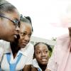 Rudolph Brown/Chief Photographer
Centenarian Catherine Reynolds tells her story to Merl Grove High School students (from left) Kristen Rhone, Tiffany Gilbert and Shaneek McPherson during the National Council for Senior Citizens/Ministry of Labour and Social Security Centenarians' Day celebration and Intergeneration Day at the council's offices in Kingston yesterday. Reynolds is 101 years old.