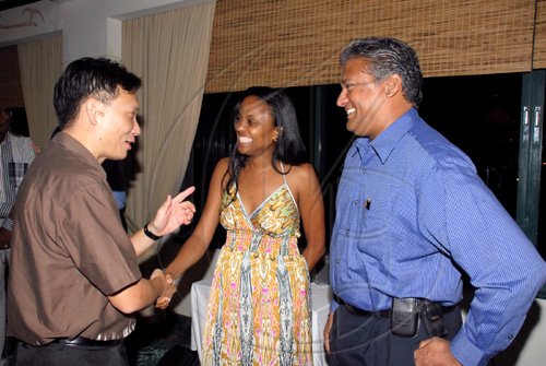 Colin?Hamilton/freelance photographer
 Trade Counsellor to Jamaica Dr. Aloysius Tay (left), gesticulates as he greets Digicel's Trisha K . Thompson while Nari Williams-Singh looks on in amusement as the Caribbean Aerospace College hosted a dinner for a Singaporean Delegation on Tuesday.

*********************************************************************comprising of members from the Singaporean Trade Counsel at the Jade Gardens Restaurant in the Sovereign Shopping Mall on Tuesday July 21, 2009.