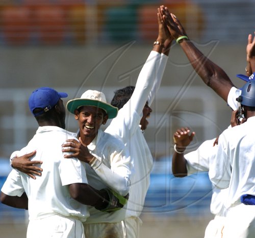 Ricardo Makyn/Staff Photographer.
Left CCC's  Wicket Keeper Walton is congratulated by Kantasingh while celebrating in the background is Bowler Austin in thier West Indies Cricket Board Championships against Jamaica on Tuesday 24.3.2009.